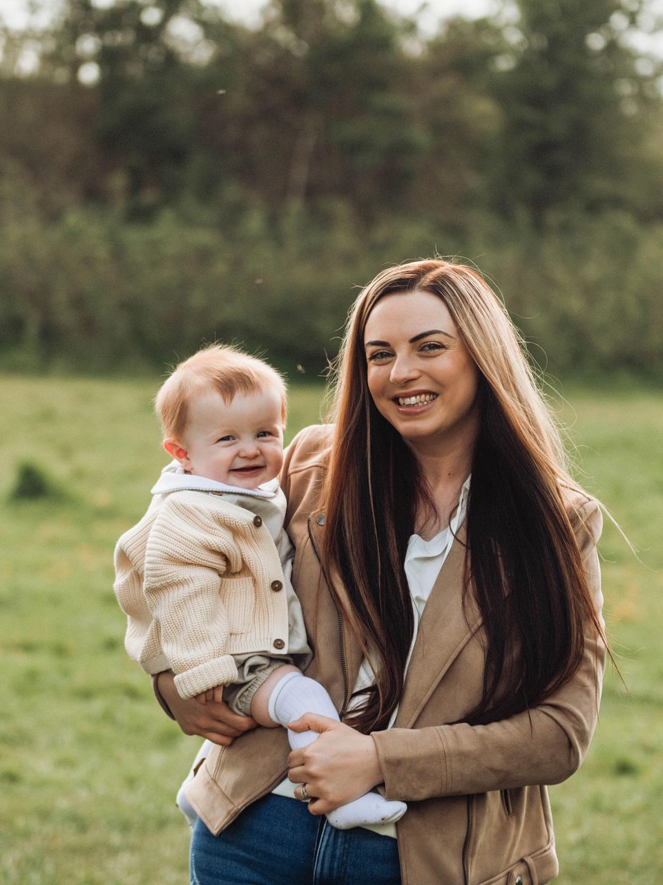 Bethany with one of her boys in a summer field