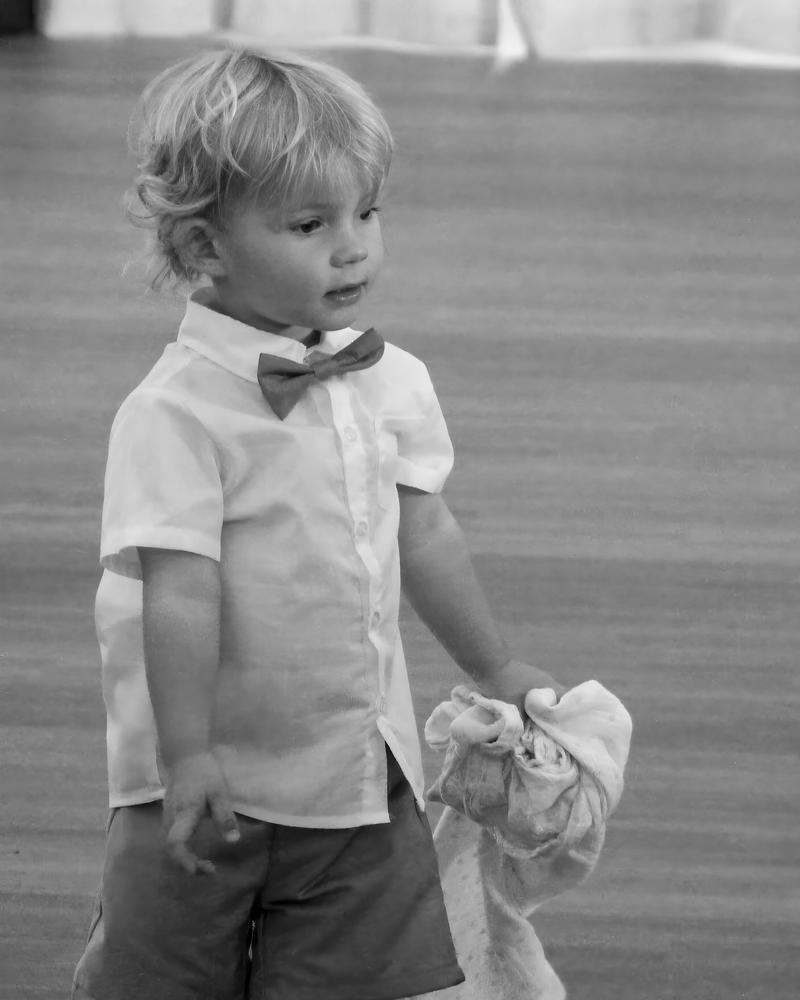 A young boy in a bow tie, in black and white
